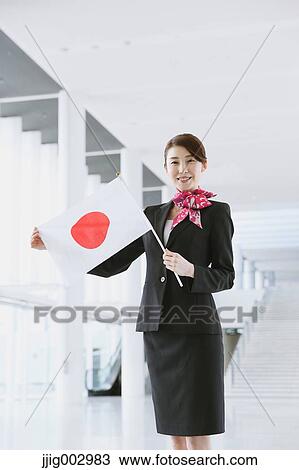 Stock Image - Japanese attractive flight attendant at the airport. Fotosearch