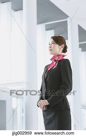 Stock Photo - Japanese attractive flight attendant at the airport. Fotosearch