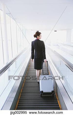 Stock Photography - Japanese attractive flight attendant at the airport. Fotosearch