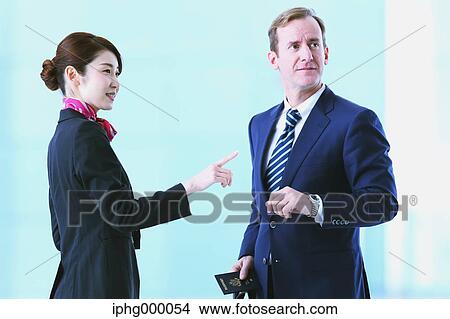 Japanese attractive flight attendant helping customer at the airport View Large Photo Image Picture - Japanese attractive flight attendant helping customer at the airport. Fotosearch