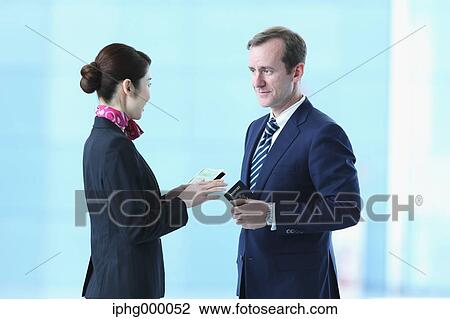 Japanese attractive flight attendant helping customer at the airport View Large Photo Image Stock Image - Japanese attractive flight attendant helping customer at the airport. Fotosearch