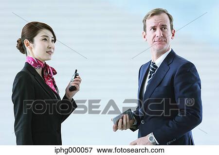 Japanese attractive flight attendant helping customer at the airport View Large Photo Image Stock Photo - Japanese attractive flight attendant helping customer at the airport. Fotosearch