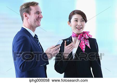 Japanese attractive flight attendant helping customer at the airport View Large Photo Image Stock Photo - Japanese attractive flight attendant helping customer at the airport. Fotosearch