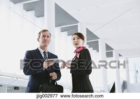Japanese attractive flight attendant helping customer at the airport View Large Photo Image Stock Photo - Japanese attractive flight attendant helping customer at the airport. Fotosearch