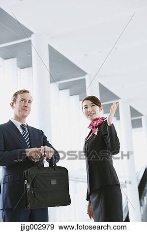 Japanese attractive flight attendant helping customer at the airport View Large Photo Image Stock Photo - Japanese attractive flight attendant helping customer at the airport. Fotosearch