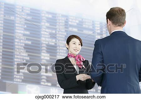 Japanese attractive flight attendant helping customer at the airport View Large Photo Image Stock Photo - Japanese attractive flight attendant helping customer at the airport. Fotosearch