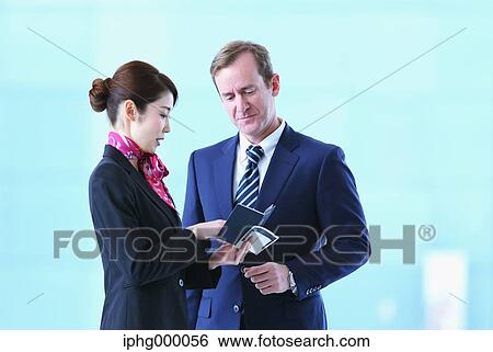 Japanese attractive flight attendant helping customer at the airport View Large Photo Image Stock Photograph - Japanese attractive flight attendant helping customer at the airport. Fotosearch
