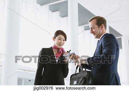 Japanese attractive flight attendant helping customer at the airport View Large Photo Image Stock Photograph - Japanese attractive flight attendant helping customer at the airport. Fotosearch