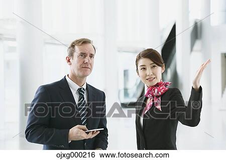 Japanese attractive flight attendant helping customer at the airport View Large Photo Image Stock Photograph - Japanese attractive flight attendant helping customer at the airport. Fotosearch