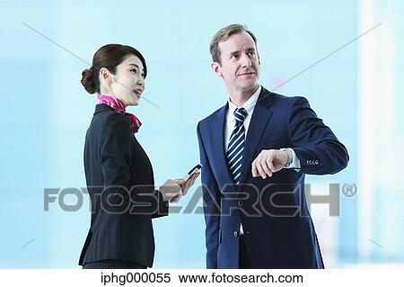 Japanese attractive flight attendant helping customer at the airport View Large Photo Image Stock Photography - Japanese attractive flight attendant helping customer at the airport. Fotosearch