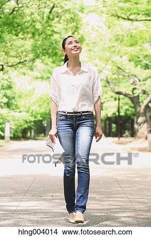 Picture - Japanese attractive woman in a city park. Fotosearch