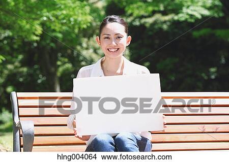 Picture - Japanese attractive woman in a city park. Fotosearch