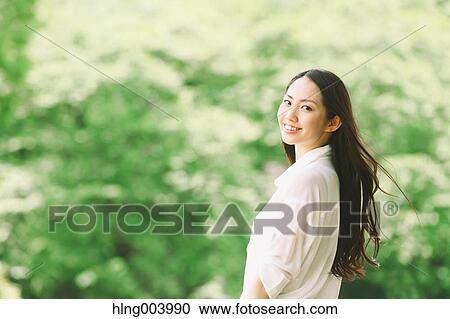 Japanese attractive woman in a city park View Large Photo Image Stock Image - Japanese attractive woman in a city park. Fotosearch