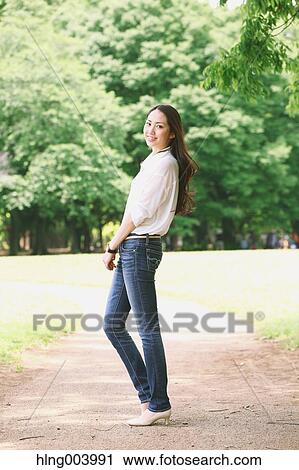 Stock Image - Japanese attractive woman in a city park. Fotosearch