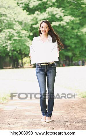 Japanese attractive woman in a city park View Large Photo Image Stock Image - Japanese attractive woman in a city park. Fotosearch