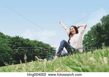 Stock Image - Japanese attractive woman in a city park. Fotosearch