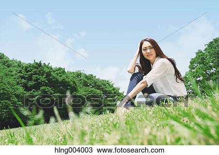 Stock Image - Japanese attractive woman in a city park. Fotosearch