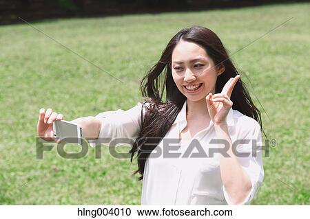 Japanese attractive woman in a city park View Large Photo Image Stock Image - Japanese attractive woman in a city park. Fotosearch