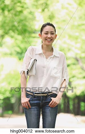 Stock Image - Japanese attractive woman in a city park. Fotosearch