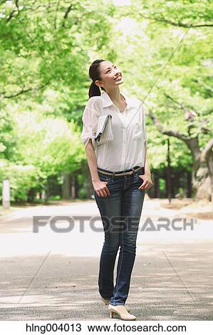 Japanese attractive woman in a city park View Large Photo Image Stock Image - Japanese attractive woman in a city park. Fotosearch