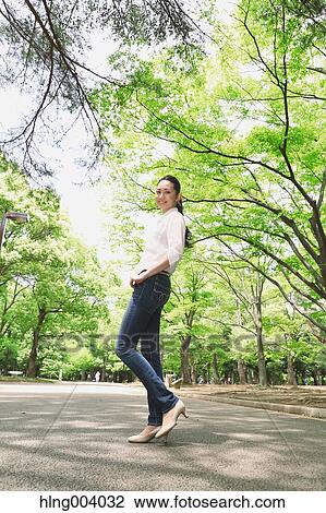 Stock Image - Japanese attractive woman in a city park. Fotosearch