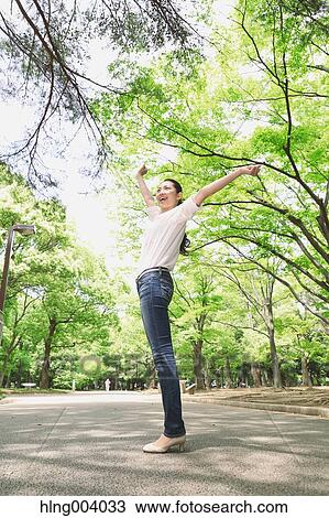 Stock Image - Japanese attractive woman in a city park. Fotosearch