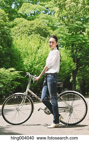 Japanese attractive woman in a city park View Large Photo Image Stock Image - Japanese attractive woman in a city park. Fotosearch