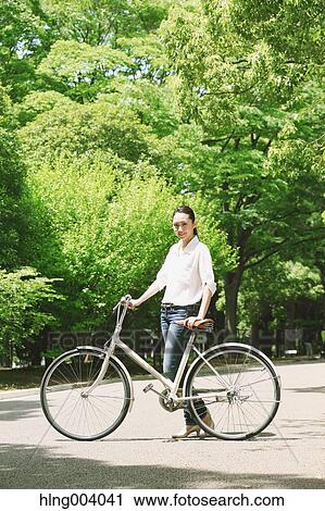 Stock Image - Japanese attractive woman in a city park. Fotosearch