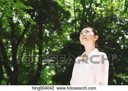 Japanese attractive woman in a city park View Large Photo Image Stock Image - Japanese attractive woman in a city park. Fotosearch