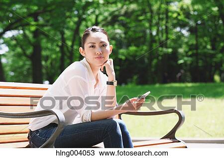 Japanese attractive woman in a city park View Large Photo Image Stock Image - Japanese attractive woman in a city park. Fotosearch