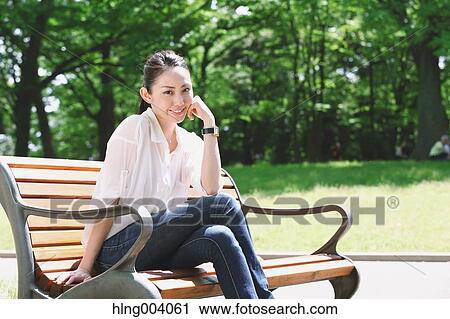 Japanese attractive woman in a city park View Large Photo Image Stock Image - Japanese attractive woman in a city park. Fotosearch