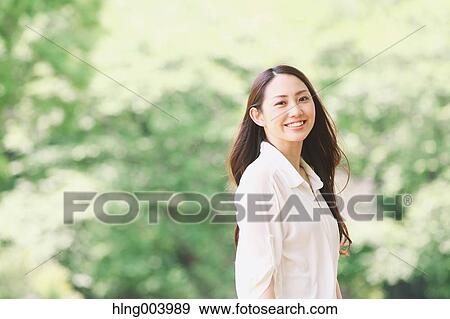 Stock Photo - Japanese attractive woman in a city park. Fotosearch
