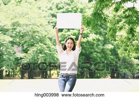 Stock Photo - Japanese attractive woman in a city park. Fotosearch