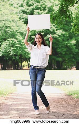 Stock Photo - Japanese attractive woman in a city park. Fotosearch