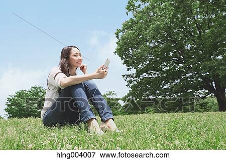 Japanese attractive woman in a city park View Large Photo Image Stock Photo - Japanese attractive woman in a city park. Fotosearch