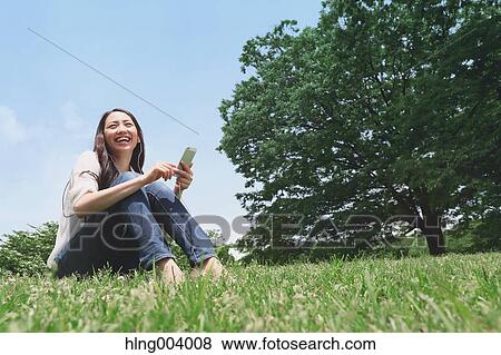 Stock Photo - Japanese attractive woman in a city park. Fotosearch