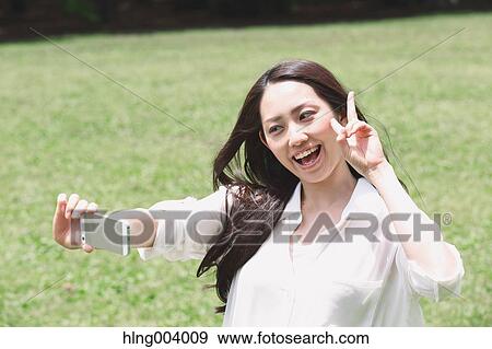 Stock Photo - Japanese attractive woman in a city park. Fotosearch