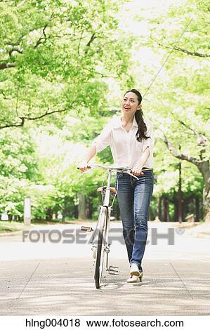 Stock Photo - Japanese attractive woman in a city park. Fotosearch