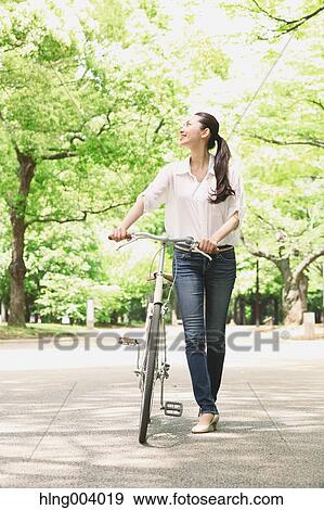 Stock Photo - Japanese attractive woman in a city park. Fotosearch