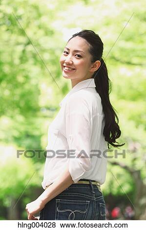 Stock Photo - Japanese attractive woman in a city park. Fotosearch