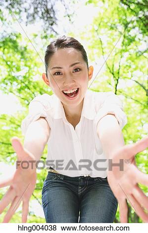 Stock Photo - Japanese attractive woman in a city park. Fotosearch
