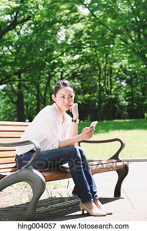 Stock Photo - Japanese attractive woman in a city park. Fotosearch
