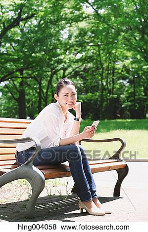Stock Photo - Japanese attractive woman in a city park. Fotosearch
