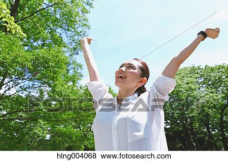 Stock Photo - Japanese attractive woman in a city park. Fotosearch