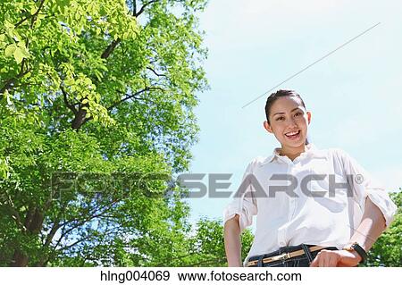 Japanese attractive woman in a city park View Large Photo Image Stock Photo - Japanese attractive woman in a city park. Fotosearch