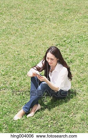 Stock Photograph - Japanese attractive woman in a city park. Fotosearch
