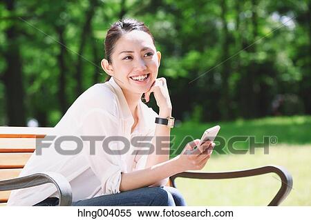 Stock Photography - Japanese attractive woman in a city park. Fotosearch