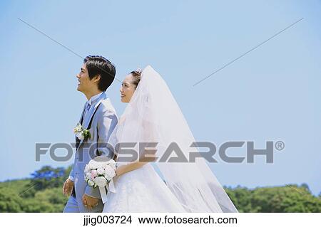 Japanese bride and groom in a city park View Large Photo Image Picture - Japanese bride and groom in a city park. Fotosearch
