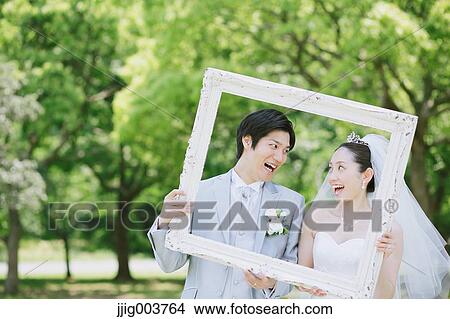 Japanese bride and groom in a city park View Large Photo Image Picture - Japanese bride and groom in a city park. Fotosearch