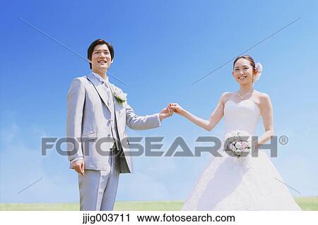 Japanese bride and groom in a city park View Large Photo Image Stock Image - Japanese bride and groom in a city park. Fotosearch